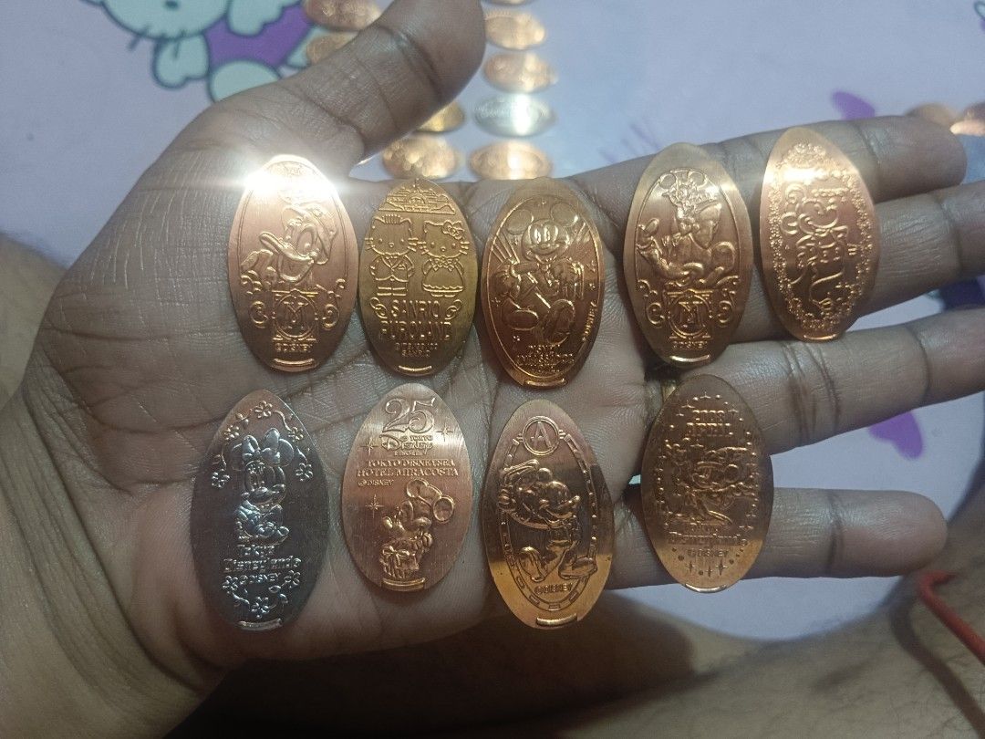 Elongated souvenir medal token (Category: Character Goods) located in Pasig City. Submitted by rednaxela_rich (Listing ID 1459794702, Image 2). Description: 46pcs assorted Disney elongated souvenir medal token sanrio/Tokyo Disneyland.