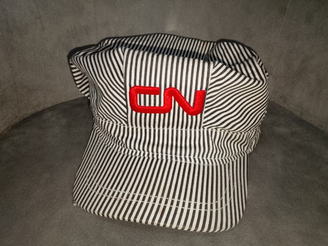 Engineer/Conductor Hat (Category: Caps & Hats) located in Binangonan. Submitted by yuristalin888 (Listing ID 1459846642, Image 2). Description: This classic black-and-white hickory stripe engineer/conductor cap features a structured high crown with red embroidered "CN" lettering on the front, a stiff curved brim, and an adjustable white plastic snapback closure in the back. NEEDS WASH!.