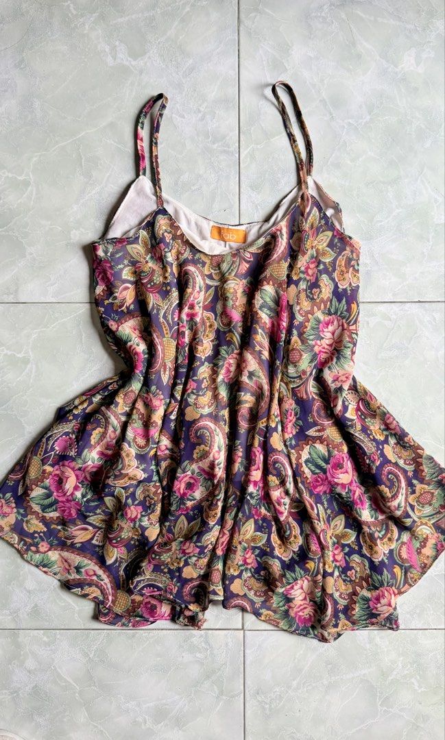 Fab Floral Print Camisole Top (Category: Sleeveless) located in General Santos City (Dadiangas). Submitted by ssssshhhhhhhhh (Listing ID 1459753355, Image 1). Description: - Adorable floral print camisole top - Sheer fabric with a delicate paisley and floral pattern - Features adjustable spaghetti straps for a perfect fit - Estimated size: Small to Medium - Versatile: Great for layering or wearing as a standalone piece - Lightweight and flowy des