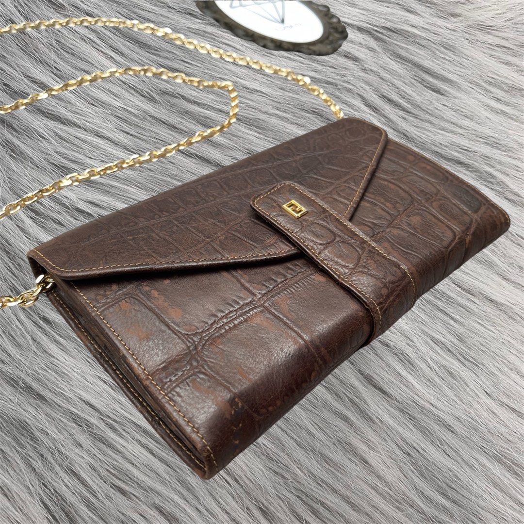 FENDI Croc Embossed Flap Wallet Clutch (Category: Luxury Bags & Wallets) located in Cagayan de Oro. Submitted by lacasaph (Listing ID 1459847636, Image 2). Description: FENDI Croc Embossed Flap Wallet Clutch • Rank AB • Rare piece! • 8 x 4.5 inches • Can fit big phones • No holes, tears on body • Can also be worn as a WOC • Free brandnew inserts and chain 🏷️ ₱2,500 **Product color may slightly vary due to photographic lighting sources or your sc