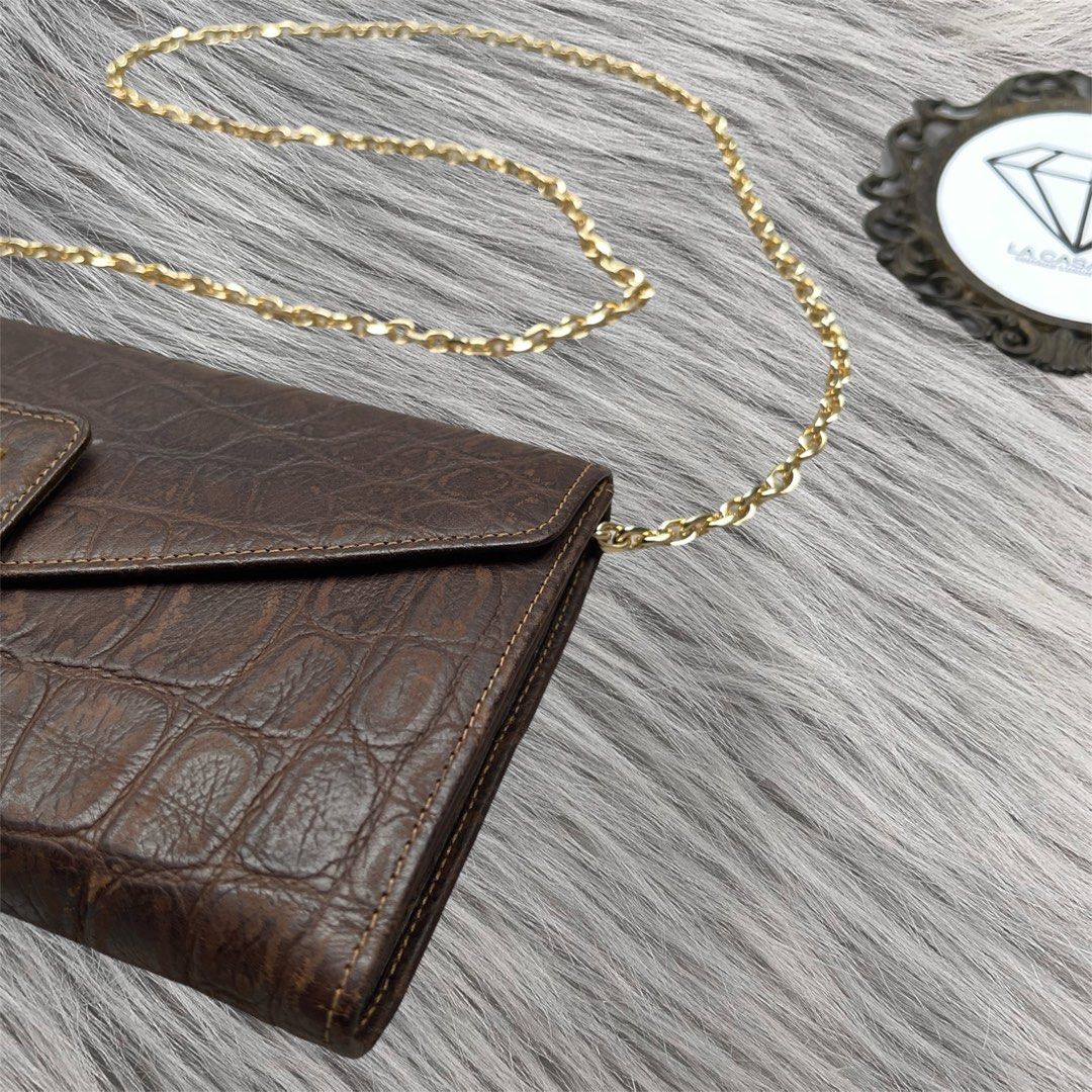 FENDI Croc Embossed Flap Wallet Clutch (Category: Luxury Bags & Wallets) located in Cagayan de Oro. Submitted by lacasaph (Listing ID 1459847636, Image 3). Description: FENDI Croc Embossed Flap Wallet Clutch • Rank AB • Rare piece! • 8 x 4.5 inches • Can fit big phones • No holes, tears on body • Can also be worn as a WOC • Free brandnew inserts and chain 🏷️ ₱2,500 **Product color may slightly vary due to photographic lighting sources or your sc