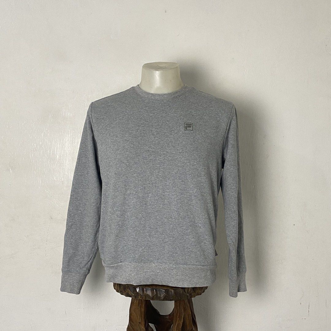 FILA ✨| Grey Classic Crewneck Sweatshirt (Category: Coats, Jackets and Outerwear) located in Bulacan. Submitted by orc.ph (Listing ID 1459804421, Image 2). Description: FILA ✨| Grey Classic Crewneck Sweatshirt Material Used: 95% Cotton 5% Spandex • Grey • Long Sleeve • Ribbed Round Neck * Ribbed Wrist Cuffs And Hem • Casual Wear •Minimalist •Drop Shoulders •Small Printed FILA Patch Logo Size: L Width: 21 Length: 23.5 Pristine Condition. No Visibl