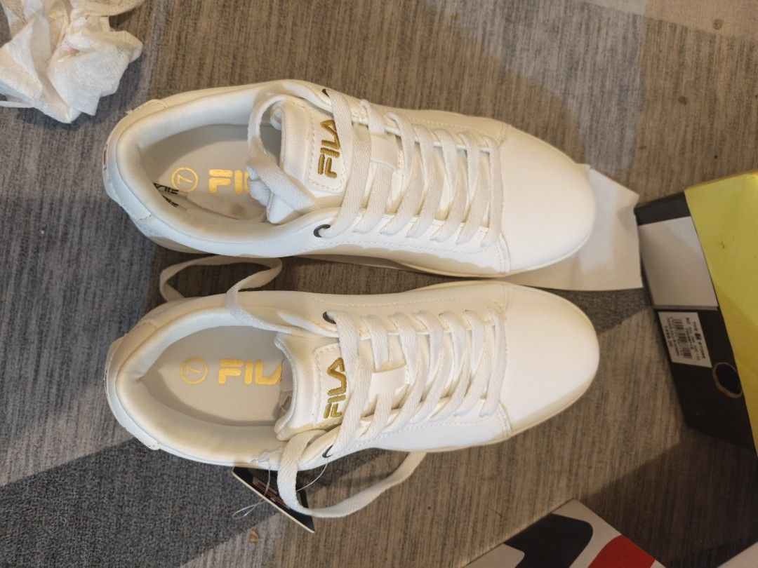 FILA Heritage Ottimista (Category: Sneakers) located in Mandaluyong City. Submitted by apparel_jenjo (Listing ID 1459861612, Image 2). Description: Model Name: FILA Heritage Ottimista Color: White / Metallic Gold Style: Low-top retro court sneaker Features: Tonal white laces, sleek stitched panels, and minimalist gold branding accents..