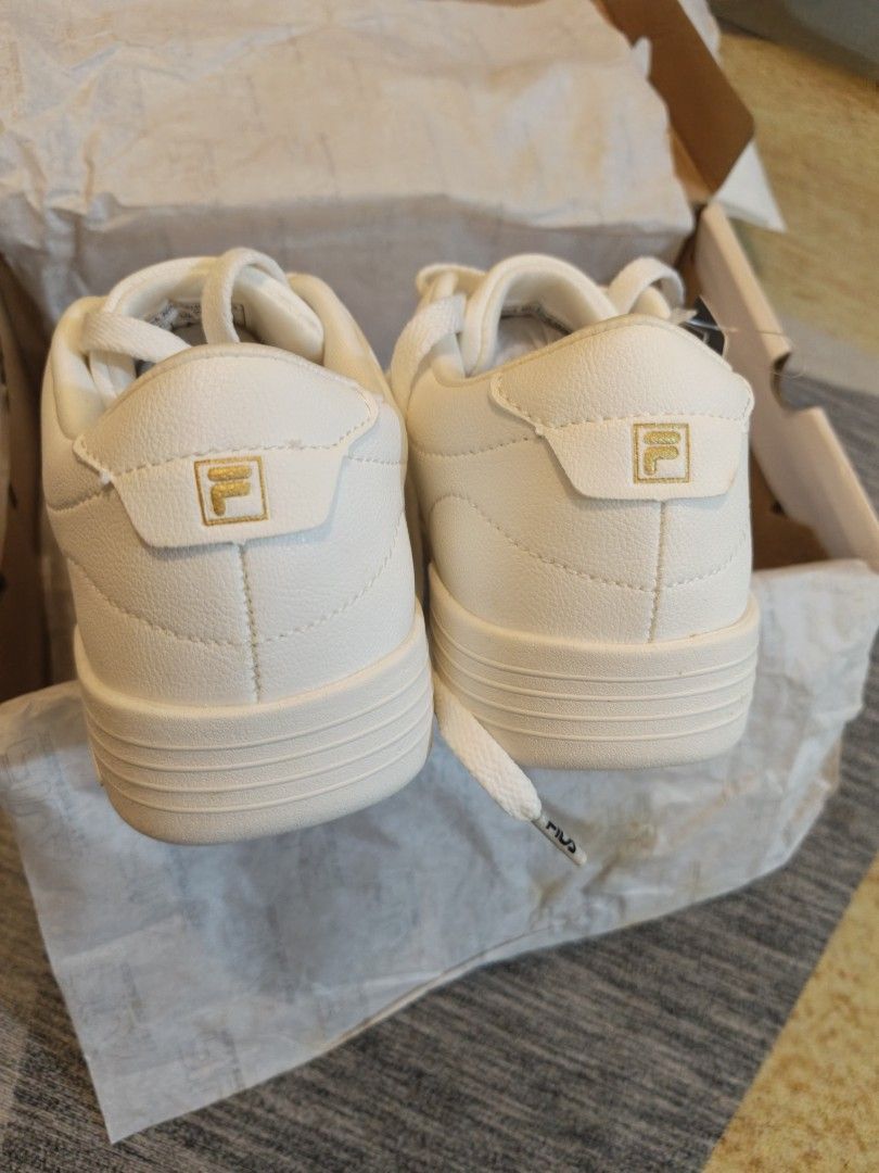 FILA Heritage Ottimista (Category: Sneakers) located in Mandaluyong City. Submitted by apparel_jenjo (Listing ID 1459861612, Image 3). Description: Model Name: FILA Heritage Ottimista Color: White / Metallic Gold Style: Low-top retro court sneaker Features: Tonal white laces, sleek stitched panels, and minimalist gold branding accents..