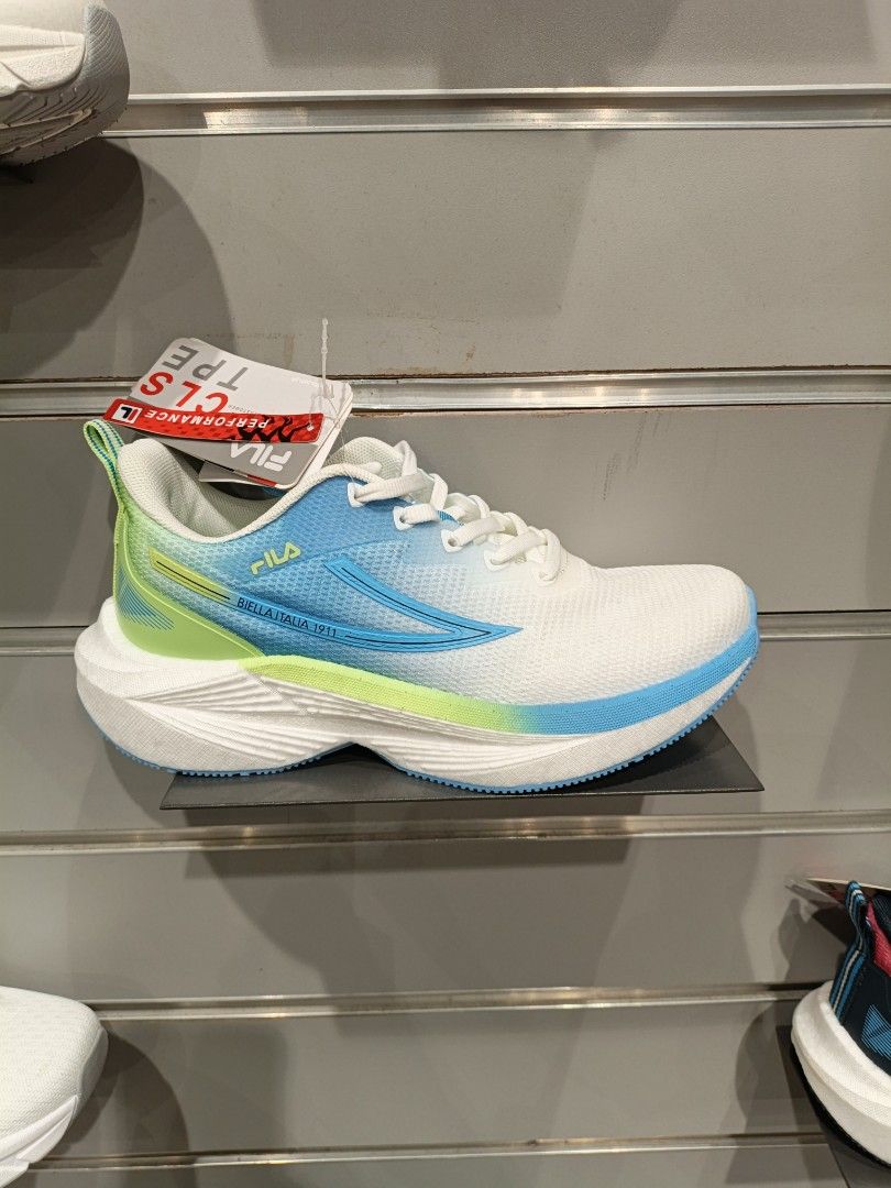 Fila Performance CLS TPE Running Shoes (Category: Sneakers) located in Santo Tomas. Submitted by Pipa.Bili.Na (Listing ID 1459769926, Image 1). Description: - White Fila running shoes - Blue and green gradient accents - "BIELLA ITALIA 1911" detail on the side - Lightweight and breathable mesh upper - Perfect for running or everyday wear - Comes with original tags lalamove buyer shoulder shipping fee mop: gcash loc: paranaque .