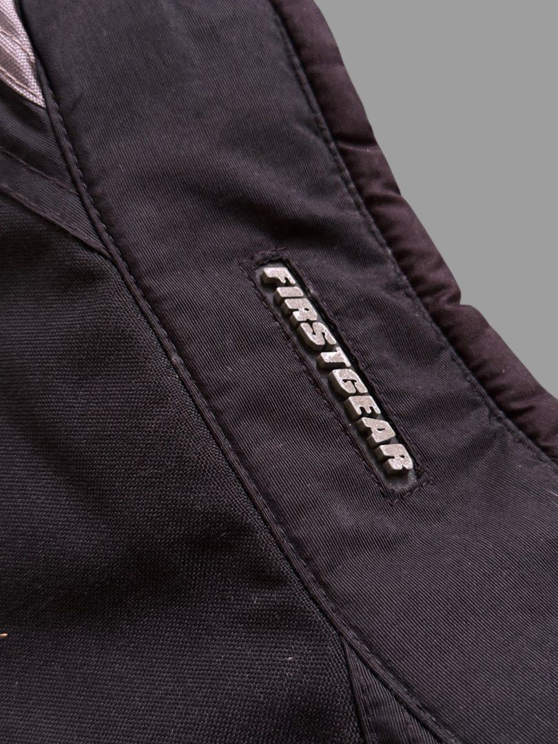 Firstgear Motorcycle Jacket (Category: Coats, Jackets and Outerwear) located in Pulilan. Submitted by _sevegn (Listing ID 1459852740, Image 3). Description: - Black and grey Firstgear motorcycle jacket - Multiple pockets on the front - Reflective piping along sleeves and back - Zipper closure - Ideal for motorcycle riding.