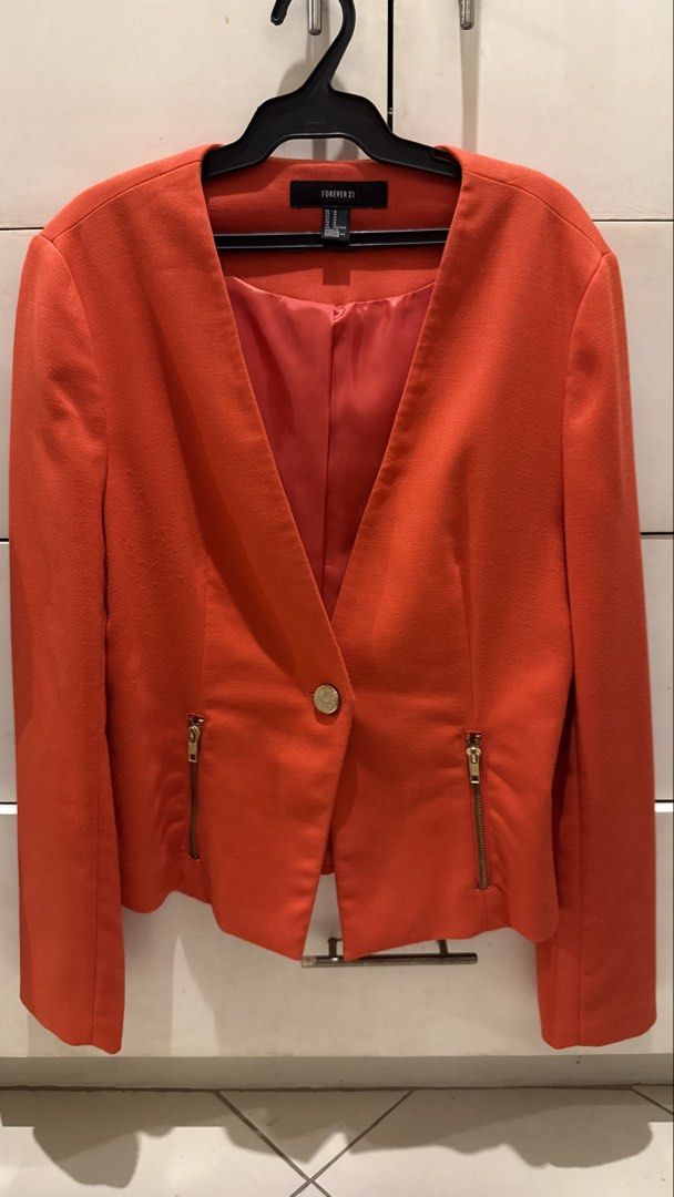 Forever 21 Orange Cropped Blazer Size M (Category: Coats, Jackets and Outerwear) located in Taytay. Submitted by kukivane (Listing ID 1459811884, Image 1). Description: - Orange cropped blazer from Forever 21 - Single button closure - Zip details on pockets - Gold button and zip accents - Versatile for dressing up or down - Size M.
