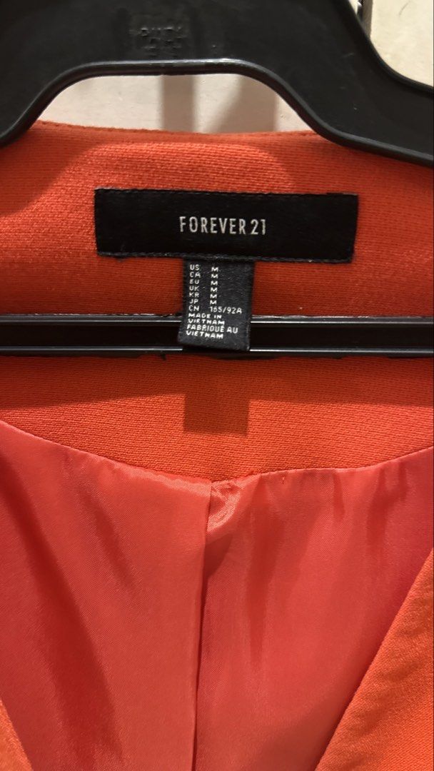 Forever 21 Orange Cropped Blazer Size M (Category: Coats, Jackets and Outerwear) located in Taytay. Submitted by kukivane (Listing ID 1459811884, Image 3). Description: - Orange cropped blazer from Forever 21 - Single button closure - Zip details on pockets - Gold button and zip accents - Versatile for dressing up or down - Size M.