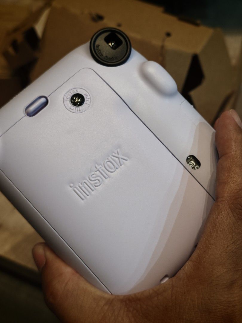Fujifilm Instax Mini 12 Camera with Accessories (Category: Cameras) located in Makati City. Submitted by musse (Listing ID 1459798799, Image 2). Description: - Fujifilm Instax Mini 12 camera in beautiful lilac color. - Comes with a stylish black camera case. - Includes a fun pack of "Patches and Stickers" with glitter eyeshadows. - All items are in their original, opened packaging. - Ideal for capturing instant photos and creating lasting memorie