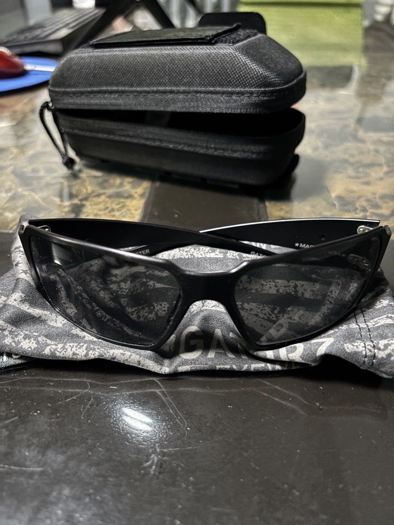 Gatorz Eyewear Sunglasses with Case and Box (Category: Sunglasses & Eyewear) located in Manila. Submitted by markjoy712 (Listing ID 1459791754, Image 1). Description: - Brand: Gatorz Sunglasses - Frame Color: Black - Lens Type: Tinted - Origin: Made in USA - Included Accessories: Protective hard case, original box, soft pouch with American flag design - Ideal For: Outdoor activities, everyday wear.