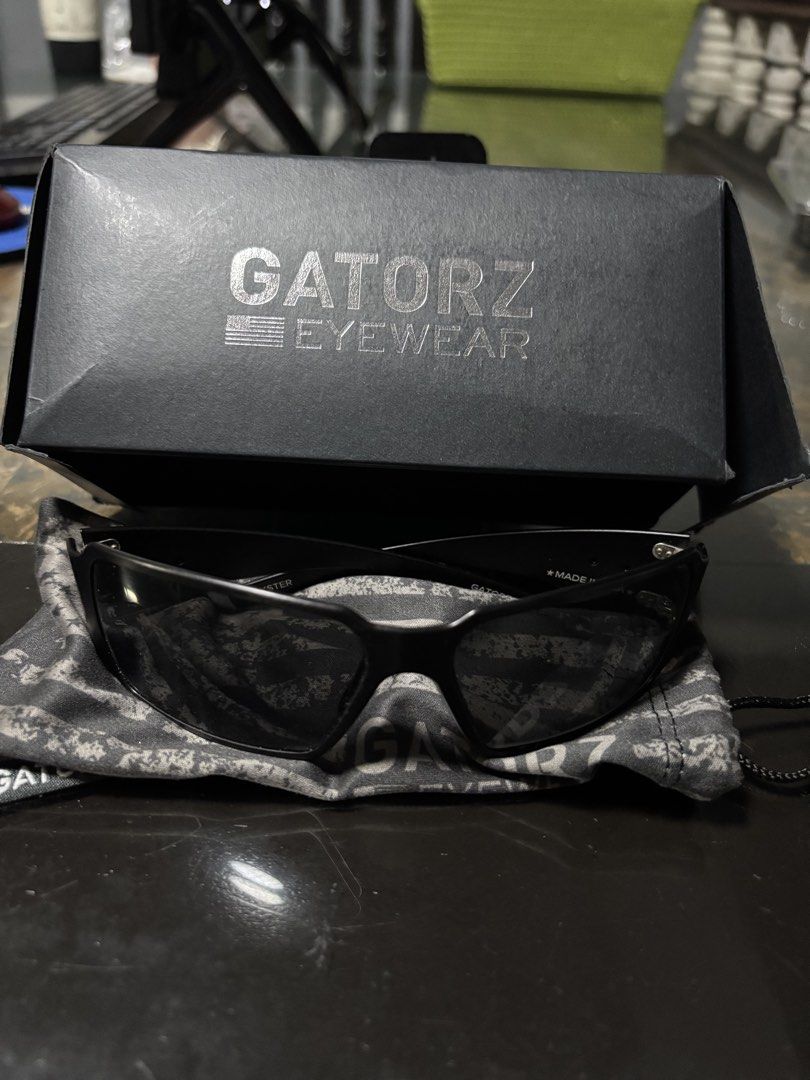 Gatorz Eyewear Sunglasses with Case and Box (Category: Sunglasses & Eyewear) located in Manila. Submitted by markjoy712 (Listing ID 1459791754, Image 2). Description: - Brand: Gatorz Sunglasses - Frame Color: Black - Lens Type: Tinted - Origin: Made in USA - Included Accessories: Protective hard case, original box, soft pouch with American flag design - Ideal For: Outdoor activities, everyday wear.