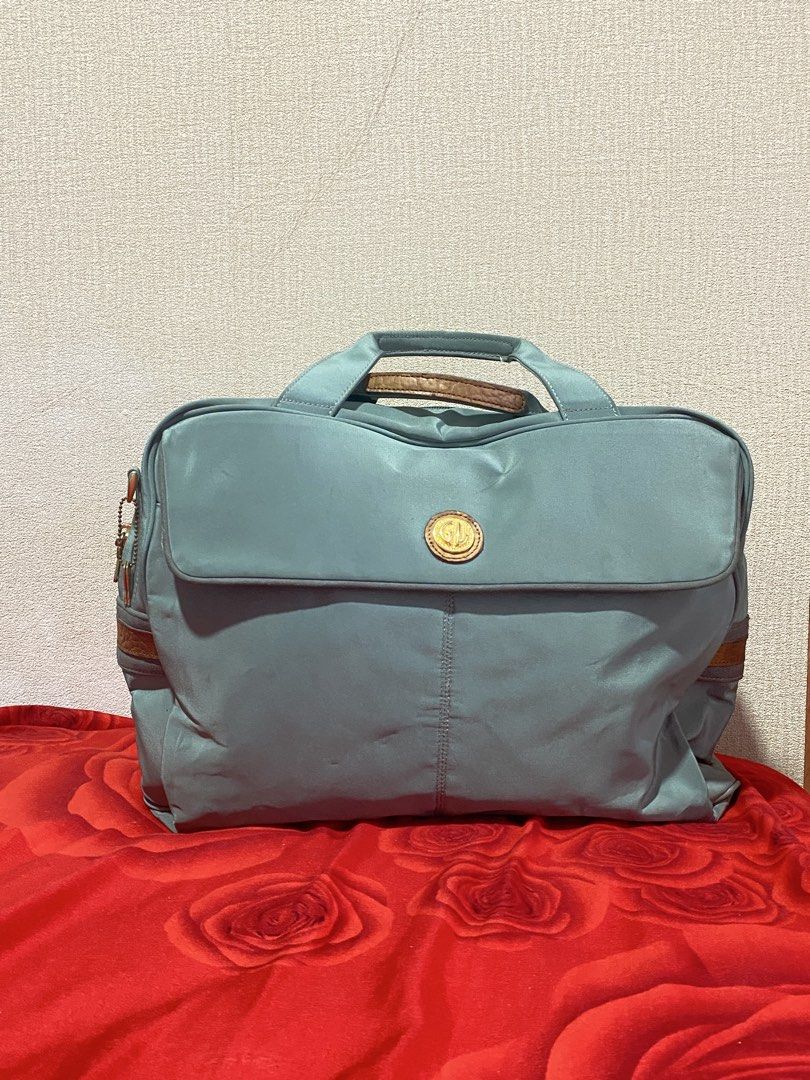 GD Daffle Bag Light Blue Nylon Leather Trim (Category: Tote Bags) located in Manila. Submitted by cdb_22 (Listing ID 1459818399, Image 1). Description: - Chic light blue tote bag with elegant leather trim. - Secure main zip compartment and a convenient back zip pocket. - Features a stylish gold-tone logo emblem on the front flap. - Comfortable leather handles for easy carrying. - Includes a detachable strap for versatile wear. - Ideal for everyda
