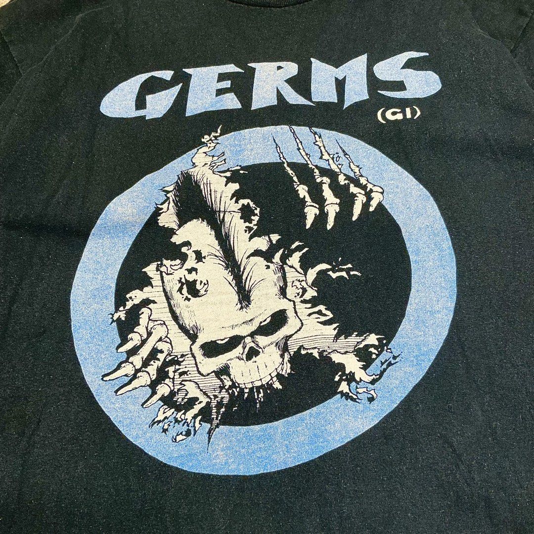 GERMS (GI) Double Layered Long Sleeve T-Shirt (Category: Tshirts & Polo Shirts ) located in Naga. Submitted by lootersfinder (Listing ID 1459780365, Image 3). Description: - Black long sleeve tee with integrated white thermal layer. - Features the distinctive GERMS (GI) graphic on the front. - Raw hem on the outer tee for a modern look. - Subtle stitching detail on the back near the collar. - Offers a unique and stylish layered aesthetic..