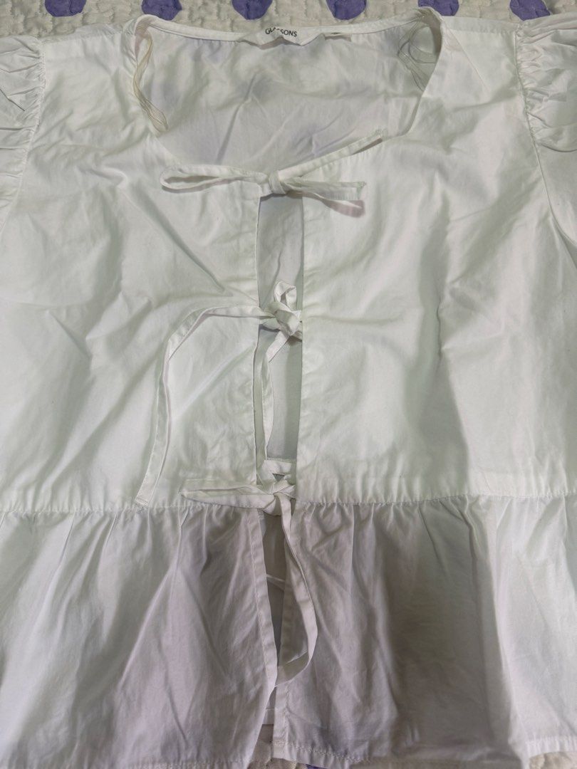 Glassons White Tie Front Peplum Top Size 12 (Category: Sleeveless) located in Muntinlupa City. Submitted by abbeyyoj (Listing ID 1459761212, Image 3). Description: -Like new - White tie-front top from Glassons - Peplum hem with short puff sleeves - Ties at the front with cute little bows - Size 12 - Made in India - Versatile for casual or dressed-up looks.