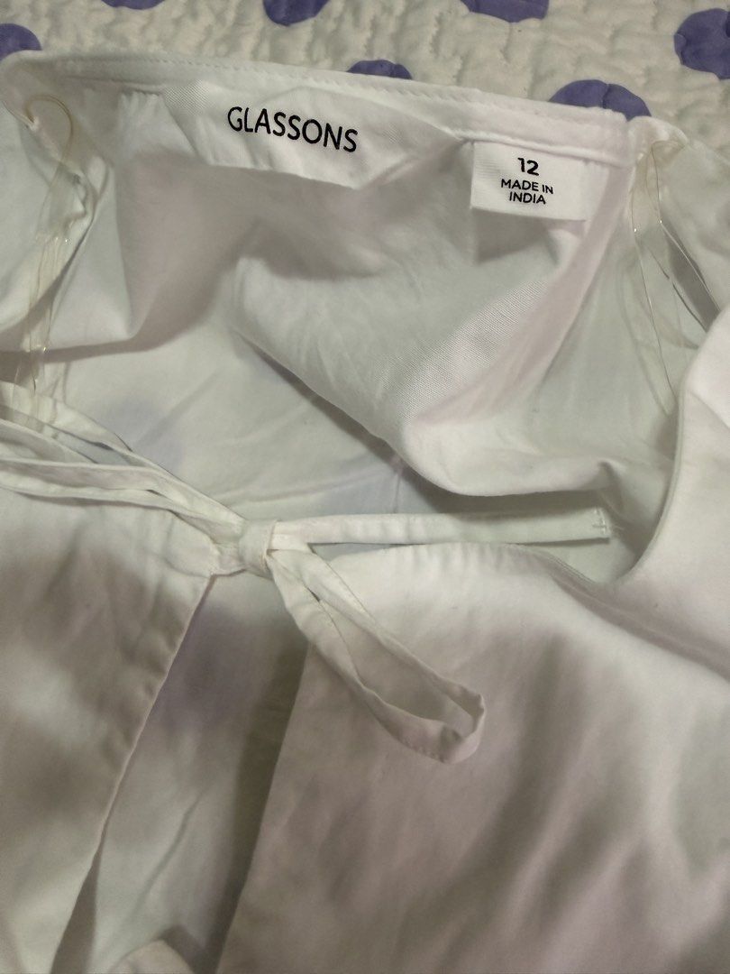Glassons White Tie Front Peplum Top Size 12 (Category: Sleeveless) located in Muntinlupa City. Submitted by abbeyyoj (Listing ID 1459761212, Image 2). Description: -Like new - White tie-front top from Glassons - Peplum hem with short puff sleeves - Ties at the front with cute little bows - Size 12 - Made in India - Versatile for casual or dressed-up looks.