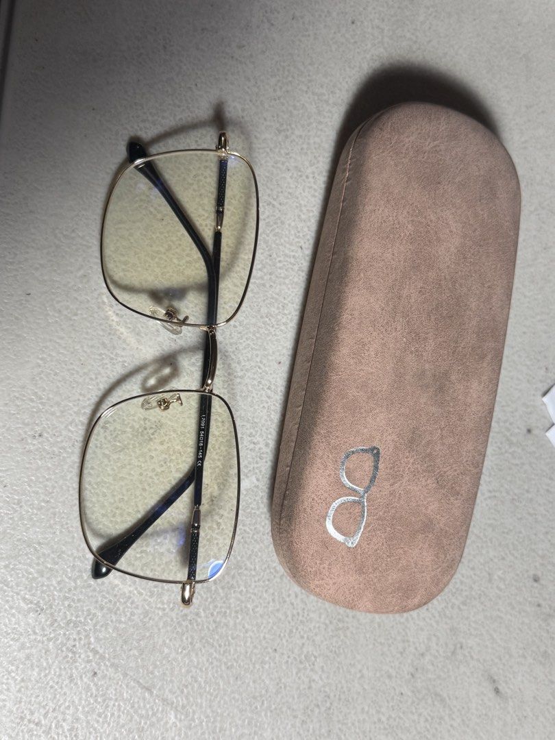 Gold Frame Blue Light Blocking Glasses with Case (Category: Sunglasses & Eyewear) located in Manila. Submitted by fridayvarias_ (Listing ID 1459721245, Image 1). Description: - Square-shaped glasses with a chic gold frame. - Lightweight and comfortable for all-day wear. - Features blue light blocking lenses, ideal for reducing eye strain during screen time. - Comes with a stylish light brown protective case. - Versatile for everyday use or as a f