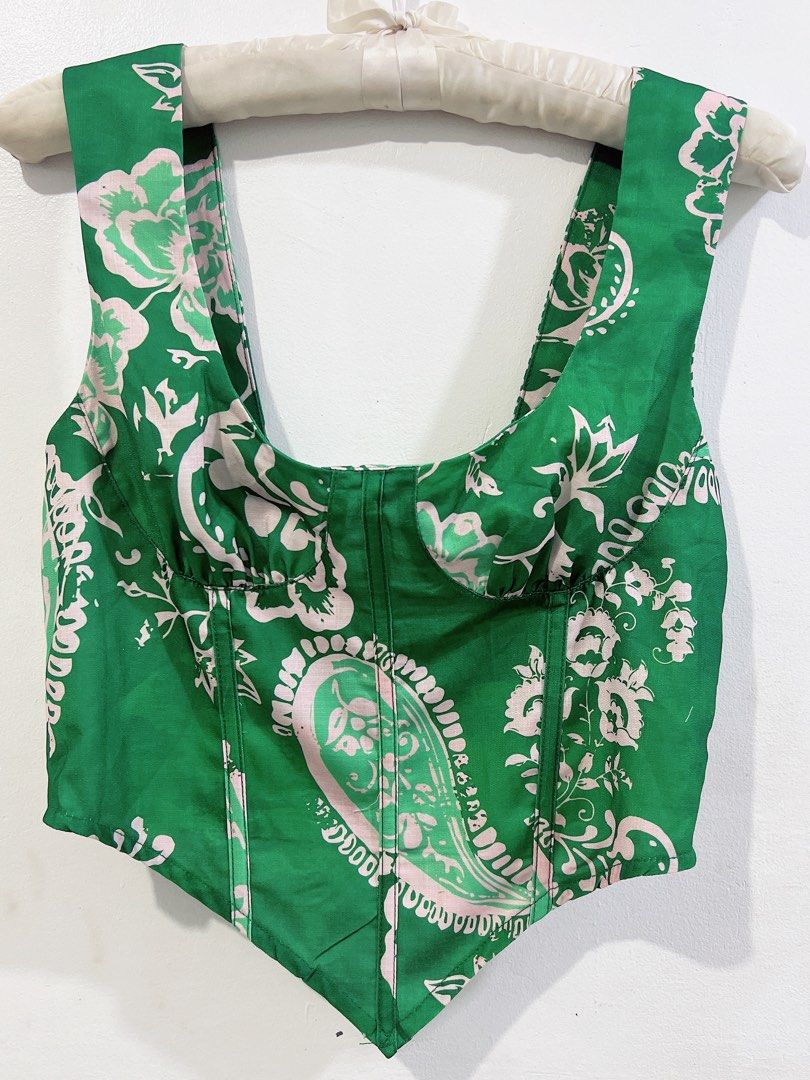 Green printed corset top (Category: Sleeveless) located in Cavite. Submitted by wishie_collects (Listing ID 1459857770, Image 3). Description: Design: A structured, scoop-neck corset top featuring vertical boning and a pointed, asymmetric hemline. Fit up to semi Med.