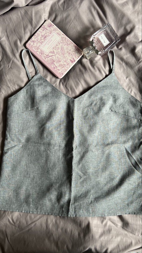 Grey Camisole Top with V-neck (Category: Sleeveless) located in Taguig. Submitted by xkmanzano078817 (Listing ID 1459756322, Image 2). Description: 🏷️ Selling at 80%off its price Plains and Prints - R.A.F Worn twice (needs to be ironed per actual picture) Seller’s Size (usually medium) Waist: 28in Bust: 33in RFS: decluttering to make space for new items Feel free to message me! Thank you 💕 - Grey camisole top - V-neck design - Relaxed fit - Ide