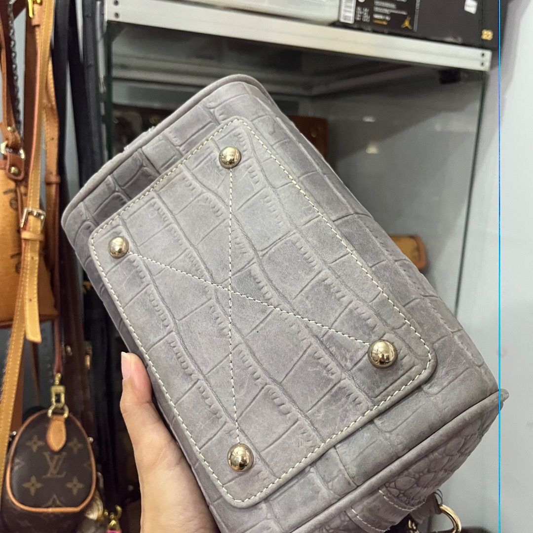 Grey Crocodile Embossed Leather Top Handle Bag with Strap (Category: Luxury Bags & Wallets) located in Cagayan de Oro. Submitted by kathkoleksyon (Listing ID 1459898639, Image 3). Description: - Stylish grey leather handbag - Elegant crocodile embossed texture - Comfortable top handles - Detachable shoulder strap for versatility - Chic gold-tone hardware - Secure zipper closure - Interior lined with vibrant blue fabric - Ideal for everyday or spe