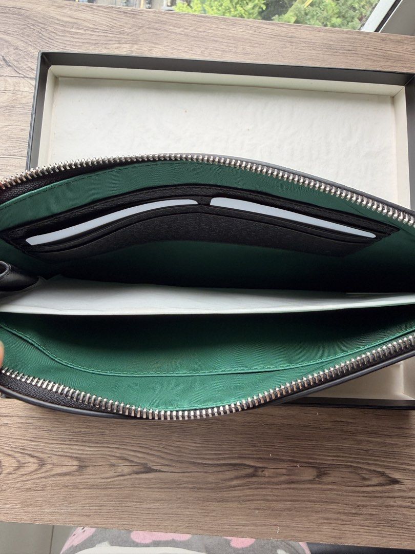 Gucci Off The Grid GG nylon Pouch (Category: Luxury Bags & Wallets) located in Manila. Submitted by starapple24_ (Listing ID 1459707745, Image 3). Description: - Authentic Gucci pouch - Green GG monogram canvas - Black leather trim and central patch - Gold embossed 'GUCCI' logo - Interior with card slots - Comes with original Gucci box - Ideal for carrying daily essentials.