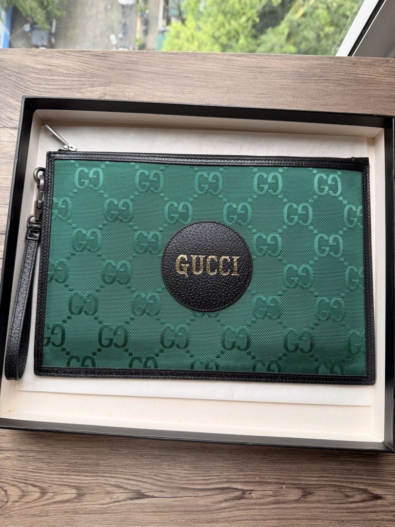 Gucci Off The Grid GG nylon Pouch (Category: Luxury Bags & Wallets) located in Manila. Submitted by starapple24_ (Listing ID 1459707745, Image 1). Description: - Authentic Gucci pouch - Green GG monogram canvas - Black leather trim and central patch - Gold embossed 'GUCCI' logo - Interior with card slots - Comes with original Gucci box - Ideal for carrying daily essentials.