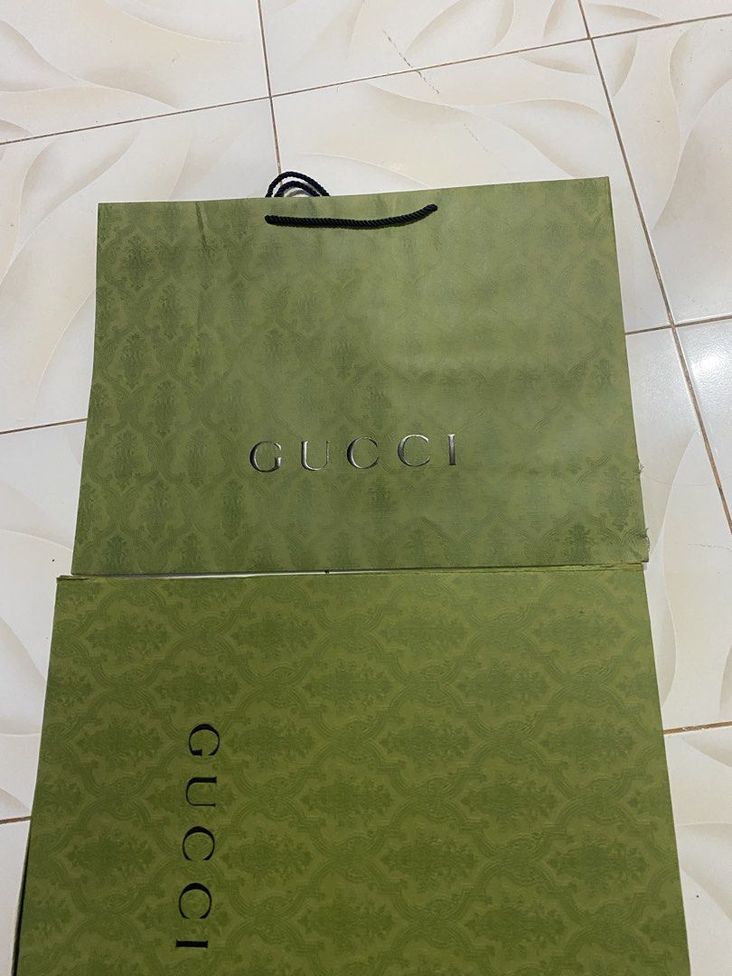 Gucci Shopping Bags (Category: Luxury Bags & Wallets) located in Bacolod City. Submitted by chuchaystuffs (Listing ID 1459717475, Image 2). Description: - Set of 2 authentic Gucci shopping bags - Classic green GG pattern - One bag features the Gucci logo in black - The other bag features the Gucci logo in silver - Ideal for storing items or as a stylish gift bag - BOTH AUTHENTIC AND IN GOOD CONDISHB.