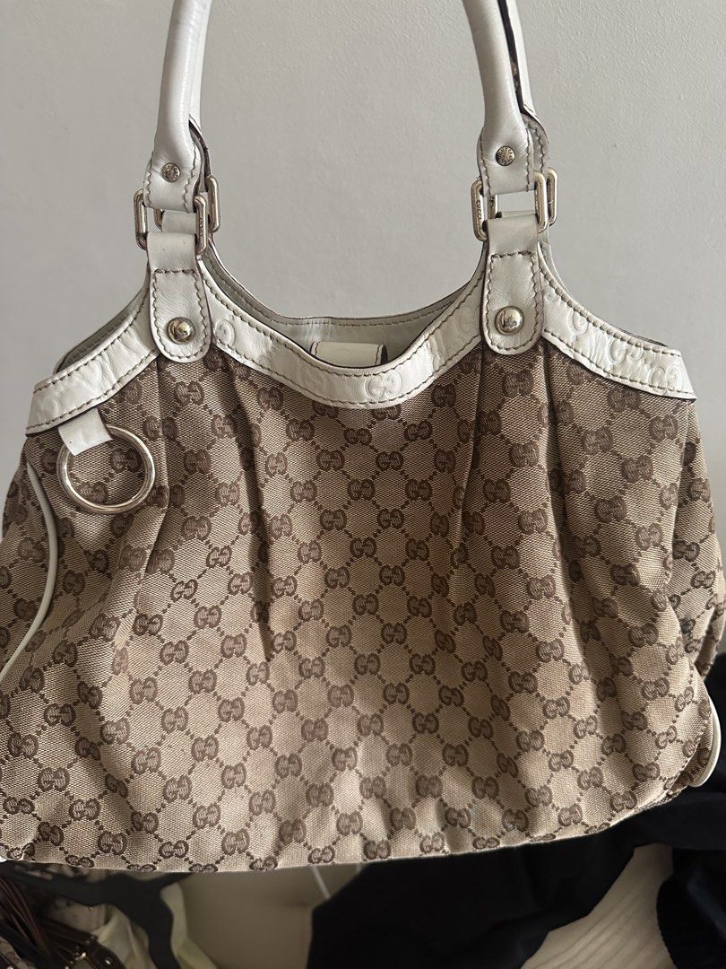 Gucci Sukey bag (Category: Luxury Bags & Wallets) located in Manila. Submitted by gentle.bagmomma (Listing ID 1459896542, Image 1). Description: - Coded Gucci shoulder bag - Classic GG monogram canvas - White leather trim and handles - Silver hardware details - Spacious interior for essentials -Just needs cleaning - Ideal for everyday use.
