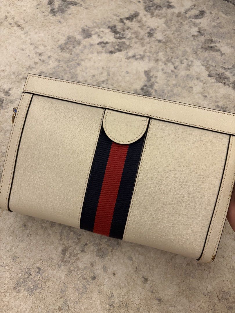 Gucci White Ophidia Chain (Category: Luxury Bags & Wallets) located in Paranaque City. Submitted by chicscloset (Listing ID 1459798707, Image 3). Description: - Authentic Gucci clutch bag - Color: Cream with signature red and blue stripe - Hardware: Gold GG logo - Includes: Dust bag, authenticity card - Perfect for: Evening events or as a statement piece.