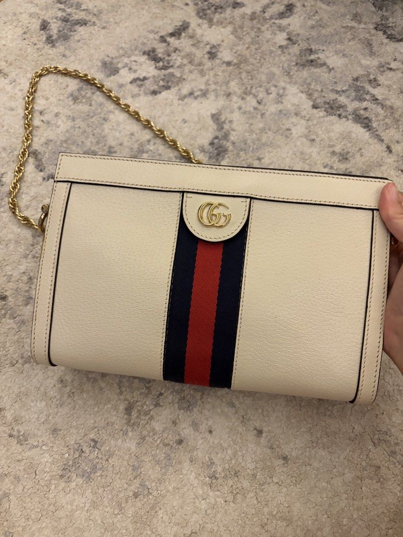 Gucci White Ophidia Chain (Category: Luxury Bags & Wallets) located in Paranaque City. Submitted by chicscloset (Listing ID 1459798707, Image 1). Description: - Authentic Gucci clutch bag - Color: Cream with signature red and blue stripe - Hardware: Gold GG logo - Includes: Dust bag, authenticity card - Perfect for: Evening events or as a statement piece.