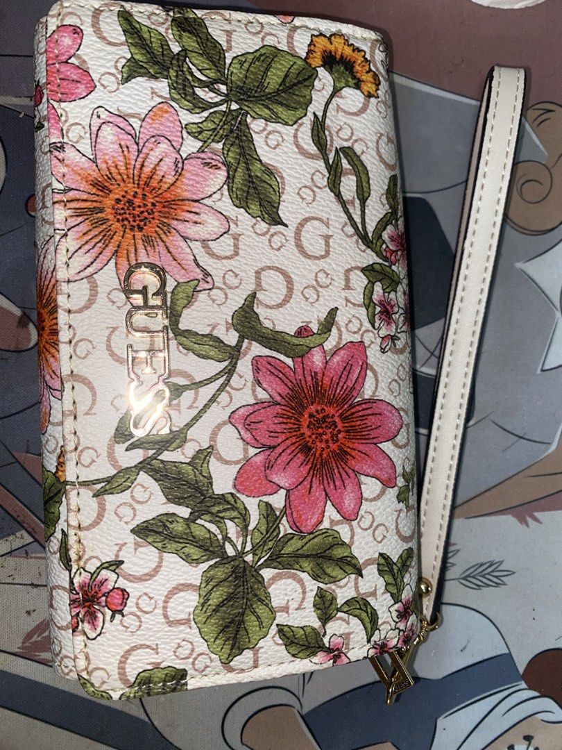Guess Floral Wallet with Wrist Strap (Category: Wallets & Card holders) located in Quezon City. Submitted by declutterei (Listing ID 1459734051, Image 2). Description: - Stylish floral print Guess wallet - Classic 'G' pattern background - Convenient wrist strap for easy carrying - Multiple interior card slots - Secure zippered compartment - Ample space for all your essentials - Ideal for daily use.