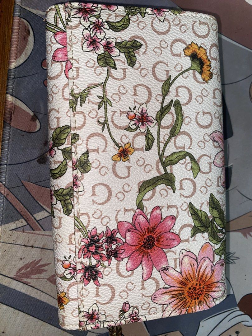 Guess Floral Wallet with Wrist Strap (Category: Wallets & Card holders) located in Quezon City. Submitted by declutterei (Listing ID 1459734051, Image 3). Description: - Stylish floral print Guess wallet - Classic 'G' pattern background - Convenient wrist strap for easy carrying - Multiple interior card slots - Secure zippered compartment - Ample space for all your essentials - Ideal for daily use.