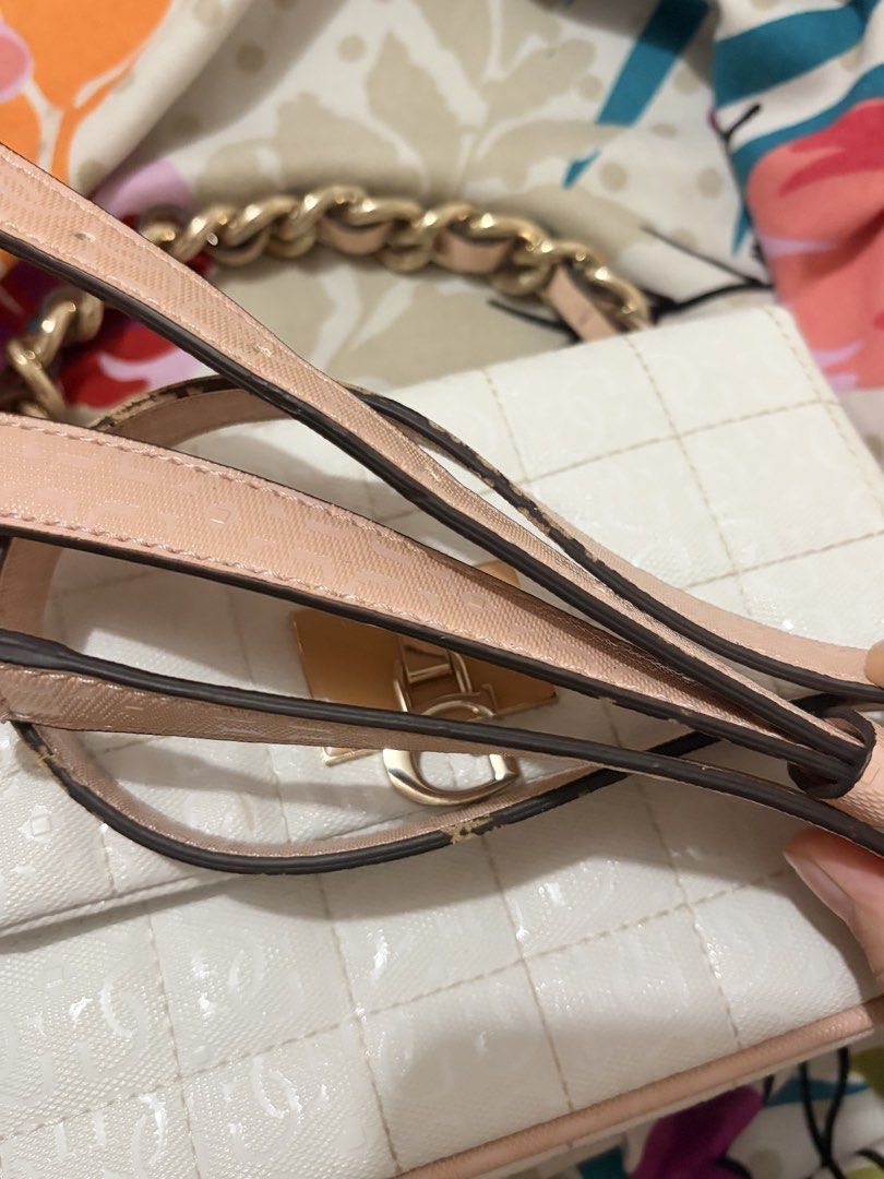 Guess Kobo Mini Crossbody Bag (Category: Luxury Bags & Wallets) located in Caloocan City. Submitted by scuideria (Listing ID 1459798601, Image 2). Description: - Stylish white Guess handbag - Elegant quilted pattern - Chic gold chain strap - Eye-catching pink trim - Secure magnetic snap closure - Interior zip pocket for essentials - Detachable strap.