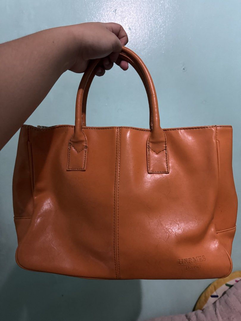 Hermes Paris Leather Tote Bag (Category: Luxury Bags & Wallets) located in Manila. Submitted by justdanzzz_ (Listing ID 1459819668, Image 3). Description: - Hermes Paris orange leather tote bag - AUTHENTICITY is not guaranteed. Check Zweely website for the product—it says "sac Hermes paris original". Buy at your own risk. - Classic design with elegant braided handles - Interior features a stylish striped lining - Simple, chic, and versatile for e
