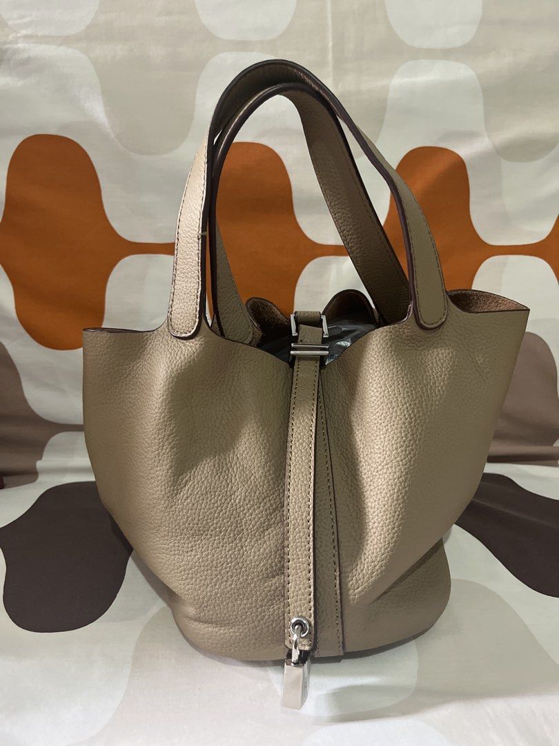 Taupe Leather Picotin Bucket Bag 22cm (Category: Luxury Bags & Wallets) located in Las Pinas. Submitted by erenrosc (Listing ID 1459737319, Image 1). Description: - Classic bucket bag style - Made from textured leather - Includes lock and key - Four protective studs on the base - Spacious interior - Comfortable top handles - Versatile for daily use.