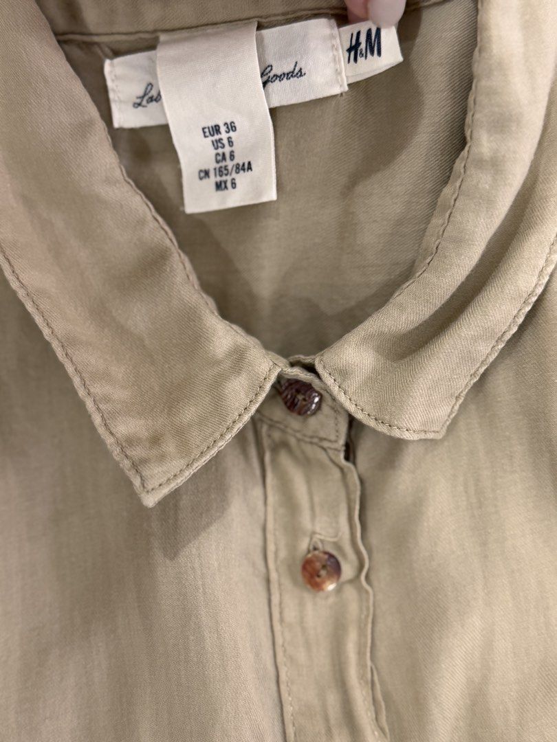 H&M Beige Short Sleeve Medium (Category: Shirts) located in Santa Rosa. Submitted by house.of.little.aya (Listing ID 1459779163, Image 3). Description: - Beige short sleeve shirt from H&M linen-like fabric, manipis pwde pang beach. - Two chest pockets with button closures - Rolled sleeve detail with button .