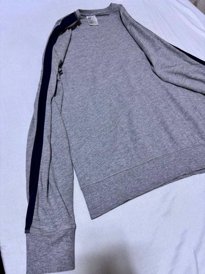 H&M Grey Sweatshirt with Navy Stripes (Category: Coats, Jackets and Outerwear) located in Pasig City. Submitted by heneralsupremo1892 (Listing ID 1459706779, Image 3). Description: - H&M Grey Long-Sleeved Sweatshirt - Features navy blue stripes on sleeves and shoulders - Ribbed cuffs and hem for a snug fit - Comfortable and casual design - Perfect for everyday wear - Authentic and Legit❗ - Very Good Condition/ Almost New 🔥 - Size: M to L🫶 - No 