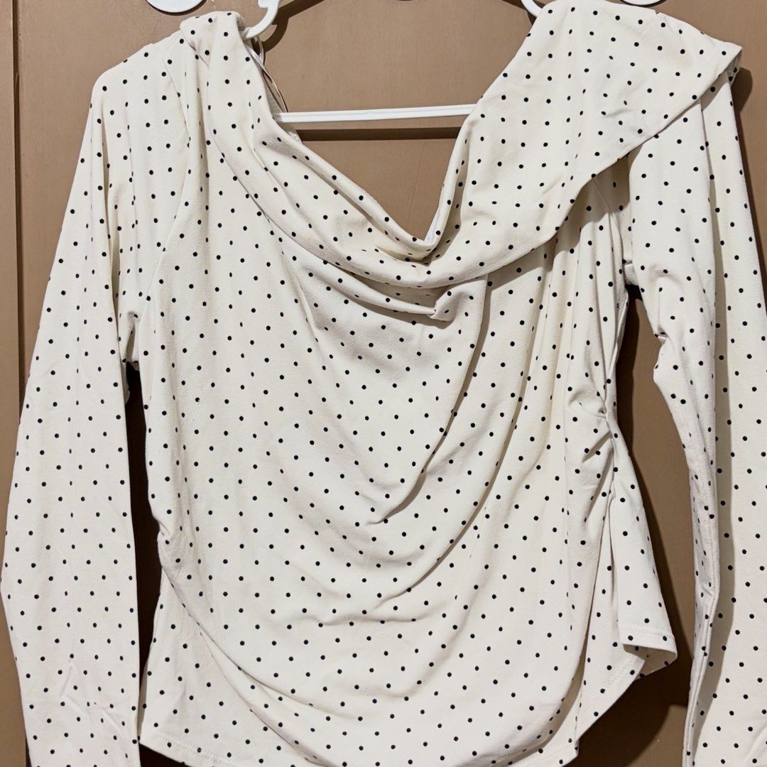 H&M Polka Dot One-Shoulder Jersey Top (Category: Sleeveless) located in Caloocan City. Submitted by zandrarubio (Listing ID 1459727281, Image 2). Description: - Cream colored top with black polka dots - Draped neckline - One-shoulder design - Long sleeves - Soft and stretchy jersey-like fabric - Versatile for dressing up or down.