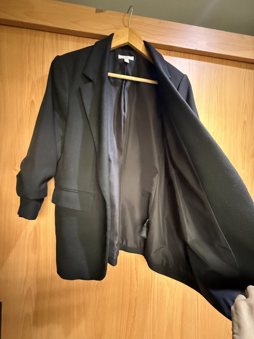 H&M solid Black Blazer Ruched Sleeves (Category: Coats, Jackets and Outerwear) located in Cavite. Submitted by galoreforsale (Listing ID 1459805615, Image 2). Description: - Classic black blazer from H&M - Unlined interior - Two front pockets - Roll-up sleeve design - Versatile for dressing up or down - Ideal for work or casual outings.