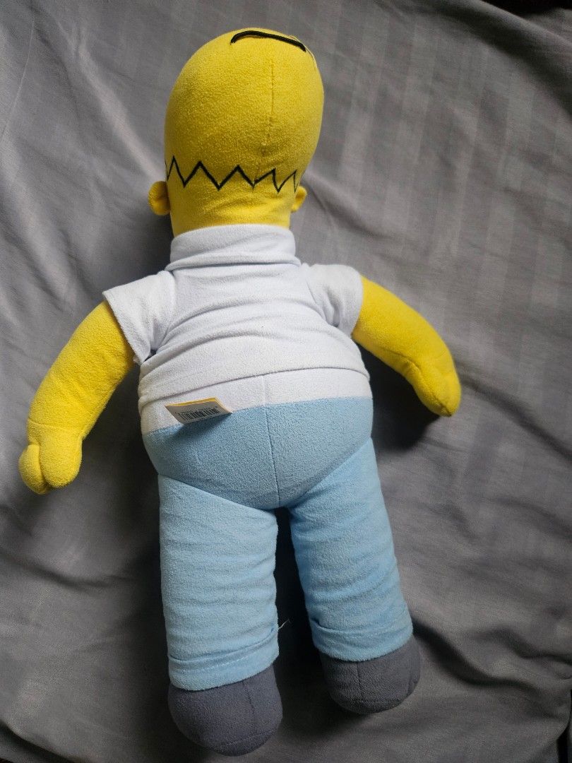 Homer Simpson Plush Toy (Category: Plushies & Soft Toys) located in Lingayen. Submitted by vargasjer57073 (Listing ID 1459737470, Image 2). Description: - Iconic Homer Simpson plush toy - Features his classic yellow head and arms - Dressed in his signature white shirt and blue pants - Complete with grey feet - A must-have for any Simpsons enthusiast - Ideal for display or cozy cuddles.