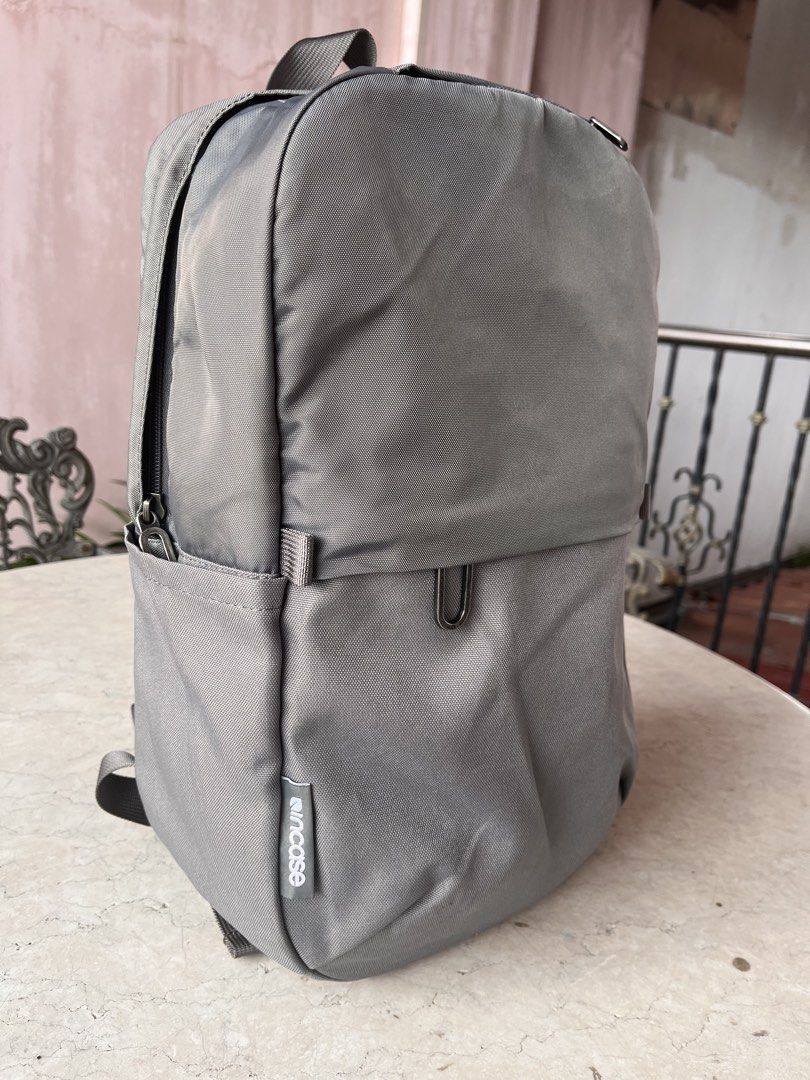 Incase Grey Medium Backpack (Category: Backpacks) located in Las Pinas. Submitted by pastel_rewind_ph (Listing ID 1459713642, Image 2). Description: Incase Grey Backpack (medium to semi-large size) - Nylon Polyester-Canvas External Fabric - 2 open pockets on the sides, 1 zipper front pocket and 1 small zipper top pocket for phone and small valuables. - Zipper Main Compartment, 4 open pockets inside and a padded laptop sleeve compartment fits 14 i