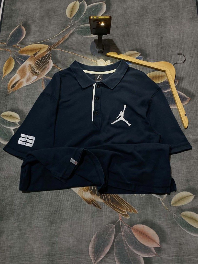 Jordan Polo (Category: Tshirts & Polo Shirts ) located in Caloocan City. Submitted by kardoyredb54515 (Listing ID 1459708514, Image 1). Description: - Navy blue Jordan polo shirt - Features embroidered Jordan logo on the sleeve - Small Jordan tag detail on the cuff - Classic polo collar design - Ideal for casual everyday wear.
