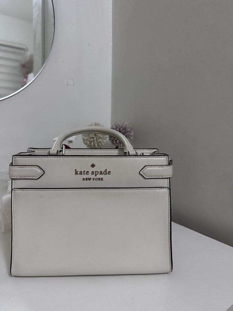 Kate Spade Staci Cameron Medium Satchel Ivory (Category: Luxury Bags & Wallets) located in Pasig City. Submitted by abbygaab (Listing ID 1459821008, Image 1). Description: - Brand: Kate Spade New York - Material: White Leather - Design: Structured top handle bag - Closure: Zip closure - Interior: Zip pocket - Hardware: Gold-tone - Strap: Detachable shoulder strap - Occasion: Great for everyday or special events.