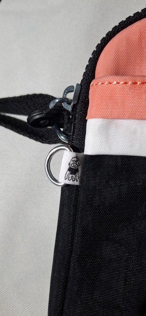 Kipling Crossbody Bag Black Coral White (Category: Cross-body Bags) located in Las Pinas. Submitted by therelovedrack (Listing ID 1459871888, Image 2). Description: Cute Kipling crossbody bag in black with coral and white stripes. Features the classic monkey tag, working zippers, and an adjustable strap. Perfect for daily use..