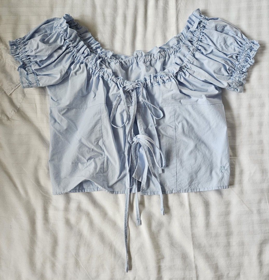 korean off-shoulder ribbon top / front tie top (Category: Blouses) located in San Juan City. Submitted by kycho348 (Listing ID 1459755352, Image 1). Description: Light blue ribbon top, bought from PLACE STUDIO (korean brand) - front ties for a customized fit, can adjust the neckline this way (offshie or short sleeves) - has buttons inside so front is secure - fits XS-M - rfs: not my style na, but super cute parin!!.