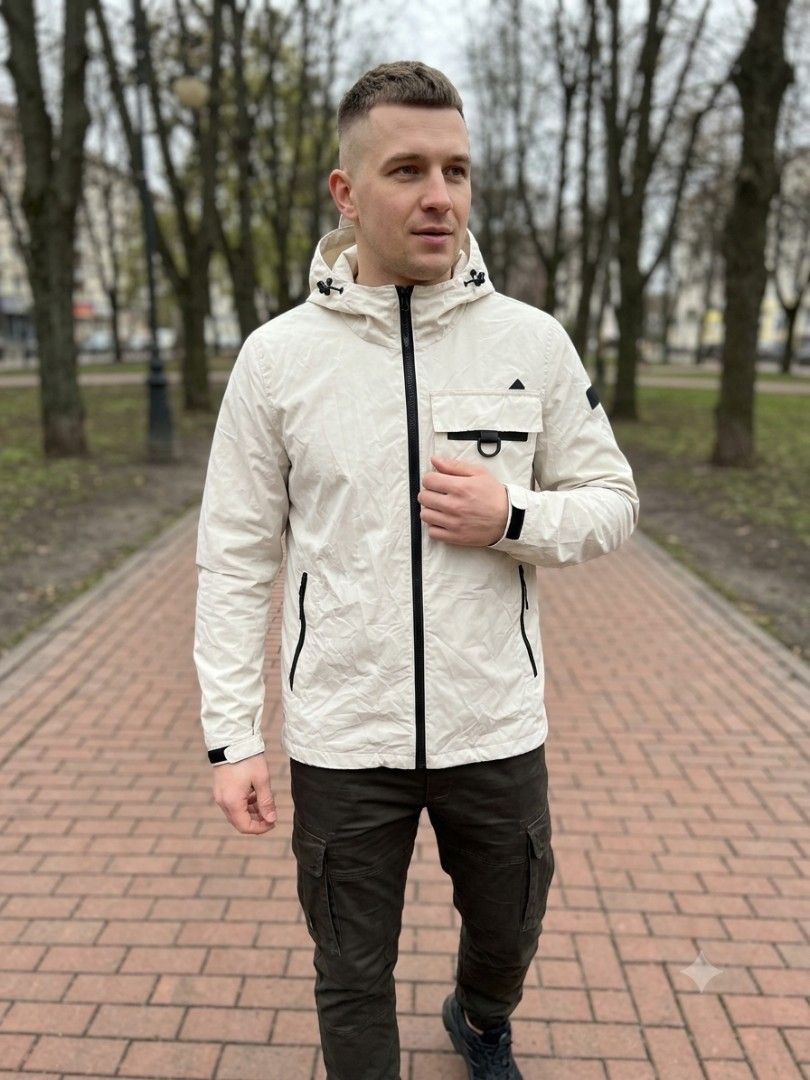 Kovea rainjacket (Category: Coats, Jackets and Outerwear) located in Manila. Submitted by captaindav11912 (Listing ID 1459703462, Image 1). Description: - Lightweight hooded jacket from Kovea - Beige color with black zippers and accents - Chest pocket with unique buckle detail - Convenient side pockets - Adjustable drawstring inside the waist for a custom fit - Ideal for outdoor adventures or everyday casual style - Packable and easy to carry -As