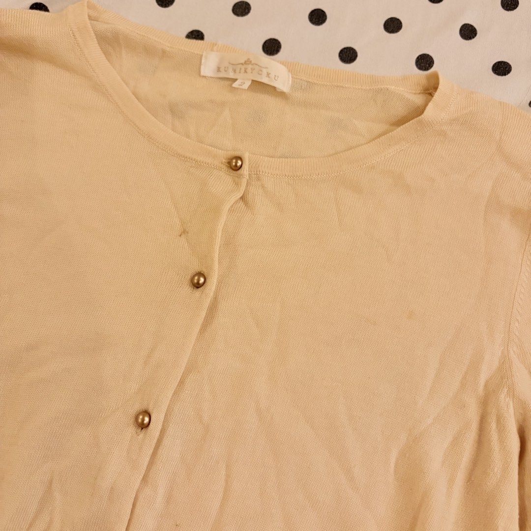 KUNIKYOKU Cream Button Up Cardigan (Category: Coats, Jackets and Outerwear) located in Pasay City. Submitted by notellyyyy (Listing ID 1459714469, Image 2). Description: see second photo for flaw - Brand: KUNIKYOKU - Color: Cream - Style: Long sleeve cardigan - Features: Button-up front, gold-toned buttons, ribbed cuffs - Material: Soft knit - Occasion: Perfect for layering over tops or dresses - Design: Simple and classic.