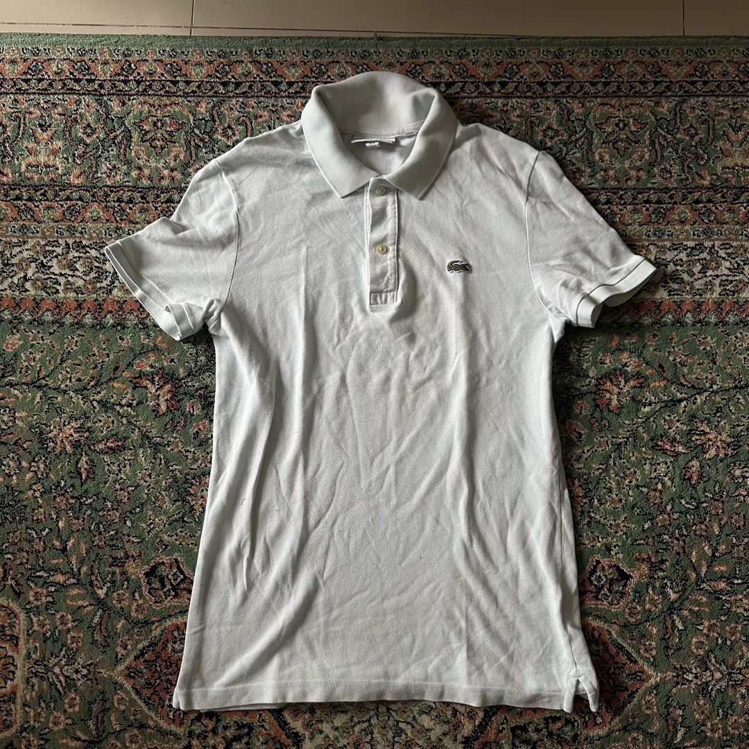 Lacoste Slim Fit Polo Shirt (Category: Tshirts & Polo Shirts ) located in Manila. Submitted by vastocean_65397b (Listing ID 1459694867, Image 1). Description: - Light blue Lacoste polo shirt - Slim fit - 100% Cotton - Classic crocodile logo on chest - Button-up neckline - Ideal for casual or smart-casual wear.