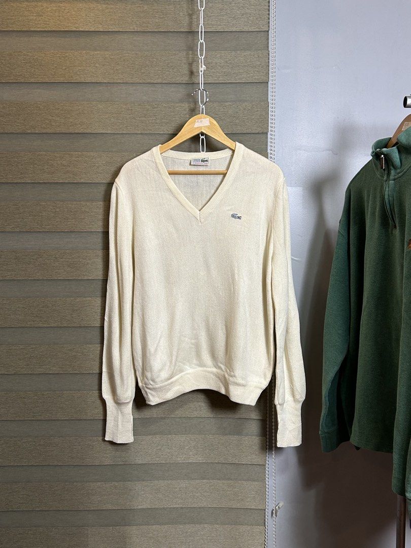Lacoste V-Neck Sweater Cream (Category: Coats, Jackets and Outerwear) located in Santa Ana. Submitted by thrift.sanctuary (Listing ID 1459732745, Image 1). Description: 28,24 Classic cream v-neck sweater from Lacoste. - Features the signature crocodile logo embroidered on the chest. - Lightweight knit, ideal for layering. - Versatile for casual or smart-casual styling. - Pairs well with jeans or trousers..