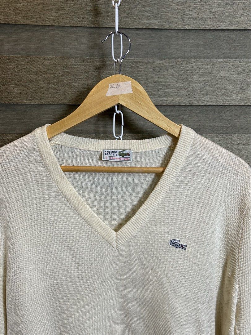 Lacoste V-Neck Sweater Cream (Category: Coats, Jackets and Outerwear) located in Santa Ana. Submitted by thrift.sanctuary (Listing ID 1459732745, Image 2). Description: 28,24 Classic cream v-neck sweater from Lacoste. - Features the signature crocodile logo embroidered on the chest. - Lightweight knit, ideal for layering. - Versatile for casual or smart-casual styling. - Pairs well with jeans or trousers..