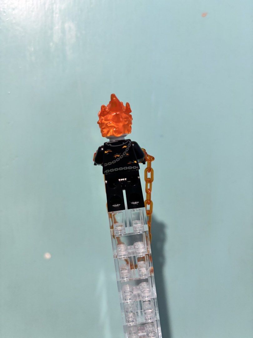 Lego Marvel Ghost Rider Minifigure with Chain (Category: Lego & Building Sets) located in Manila. Submitted by blueboxcollectibles (Listing ID 1459786866, Image 2). Description: - Authentic Lego Marvel Ghost Rider minifigure - Features iconic flaming head - Includes translucent orange chain accessory - Must-have for Marvel and Lego collectors.